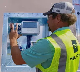 A Velociti technician installing a Phillips Connect telematics device on a trailer.